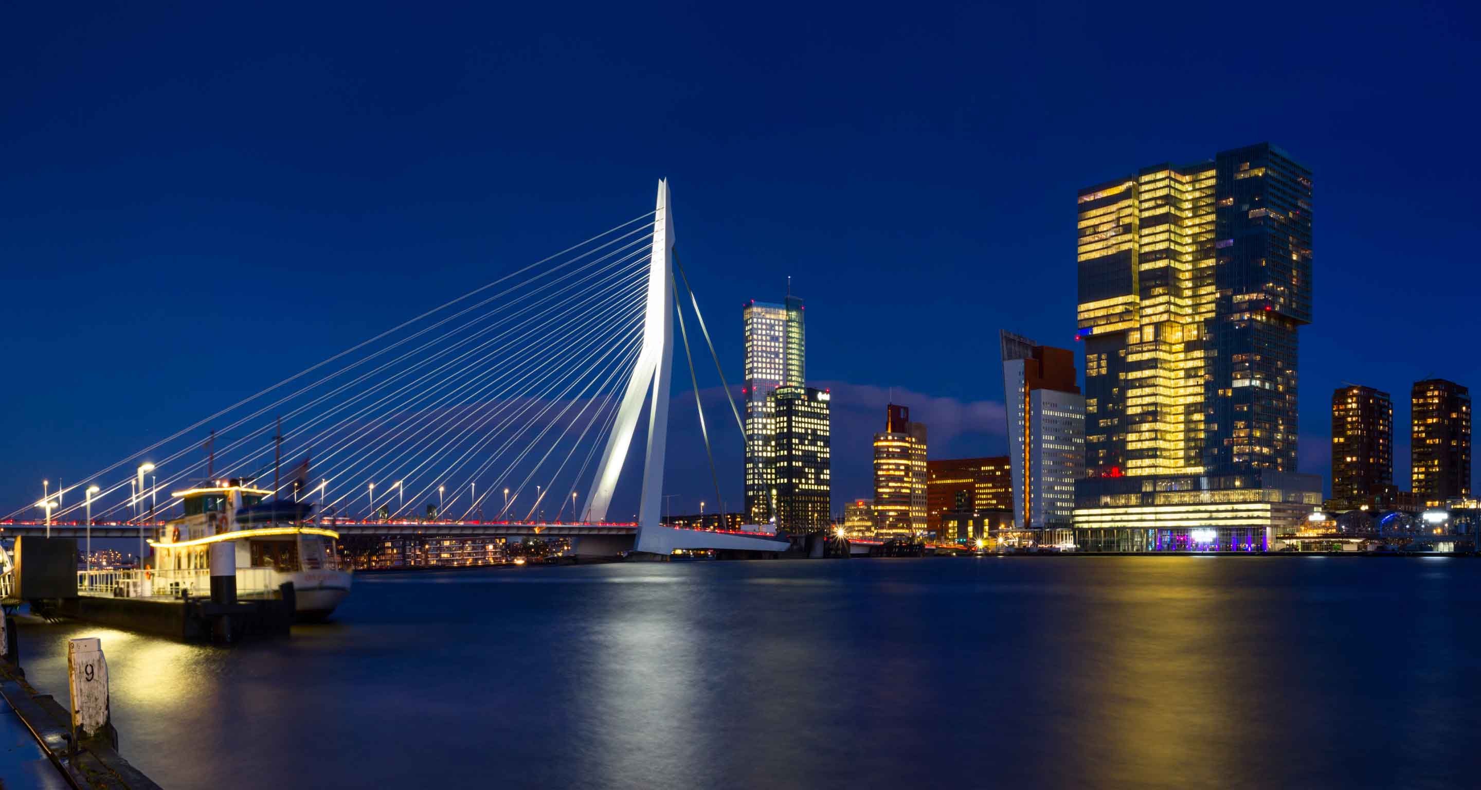 Erasmus Bridge and De Rotterdam at night.